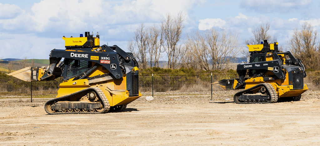 Two John Deere loaders equipped with Teleo's autonomous technology